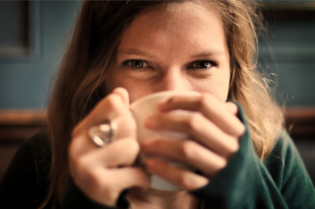 woman drinking blue lotus tea